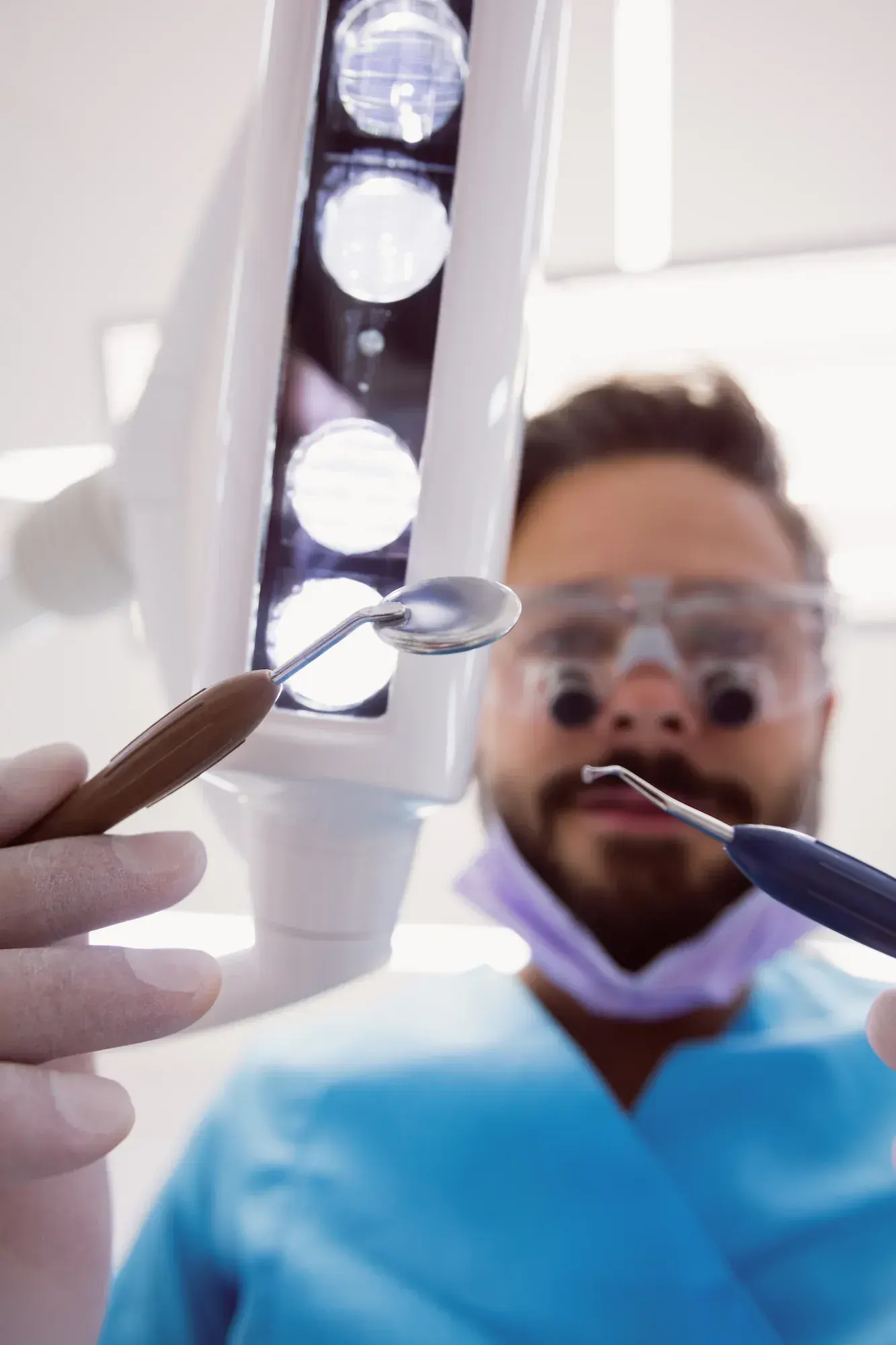 Side-by-side view of intra-oral camera image on a monitor next to a patient in the dental chair