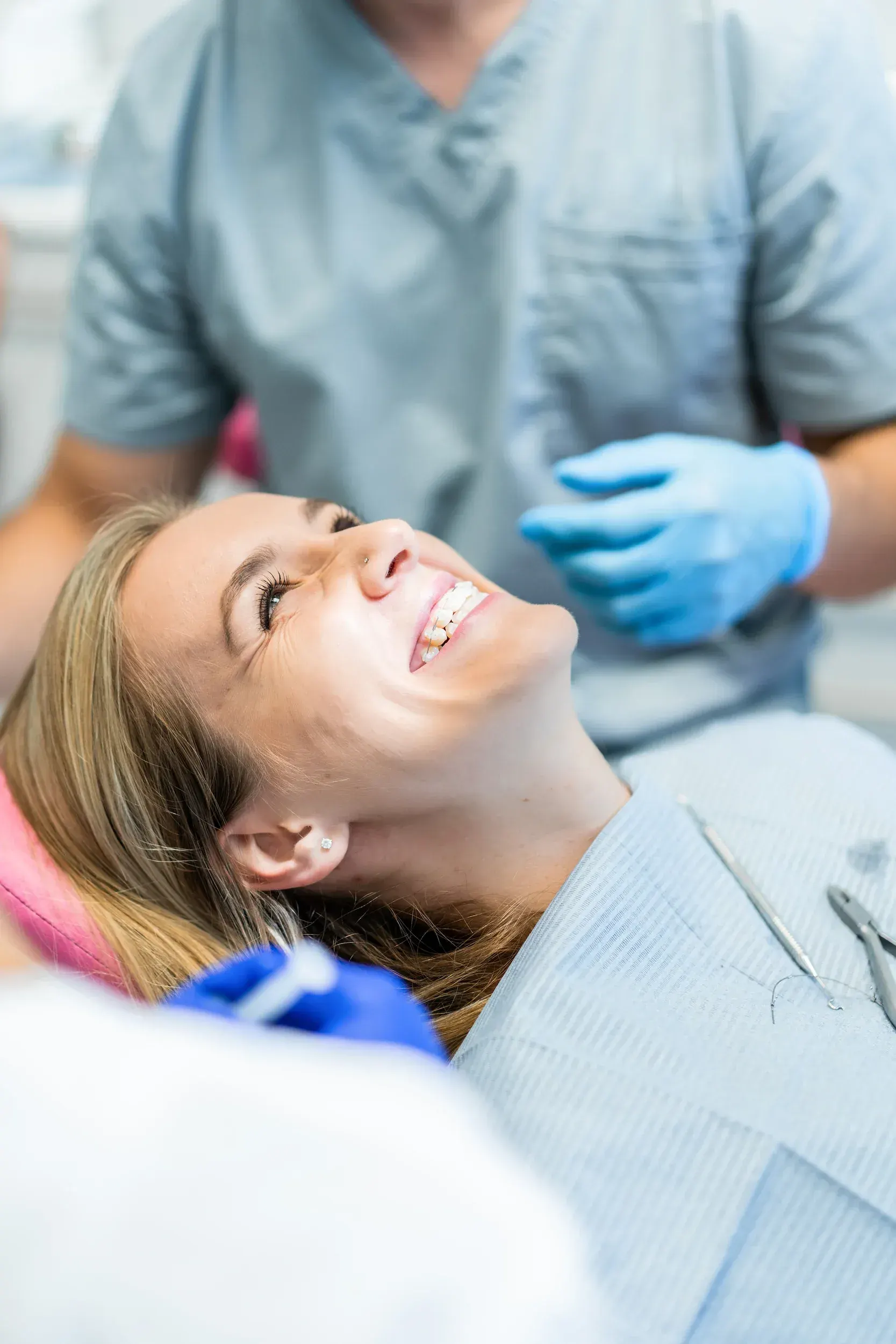 Side by side comparison of Invisalign clear aligner and traditional metal braces on dental models