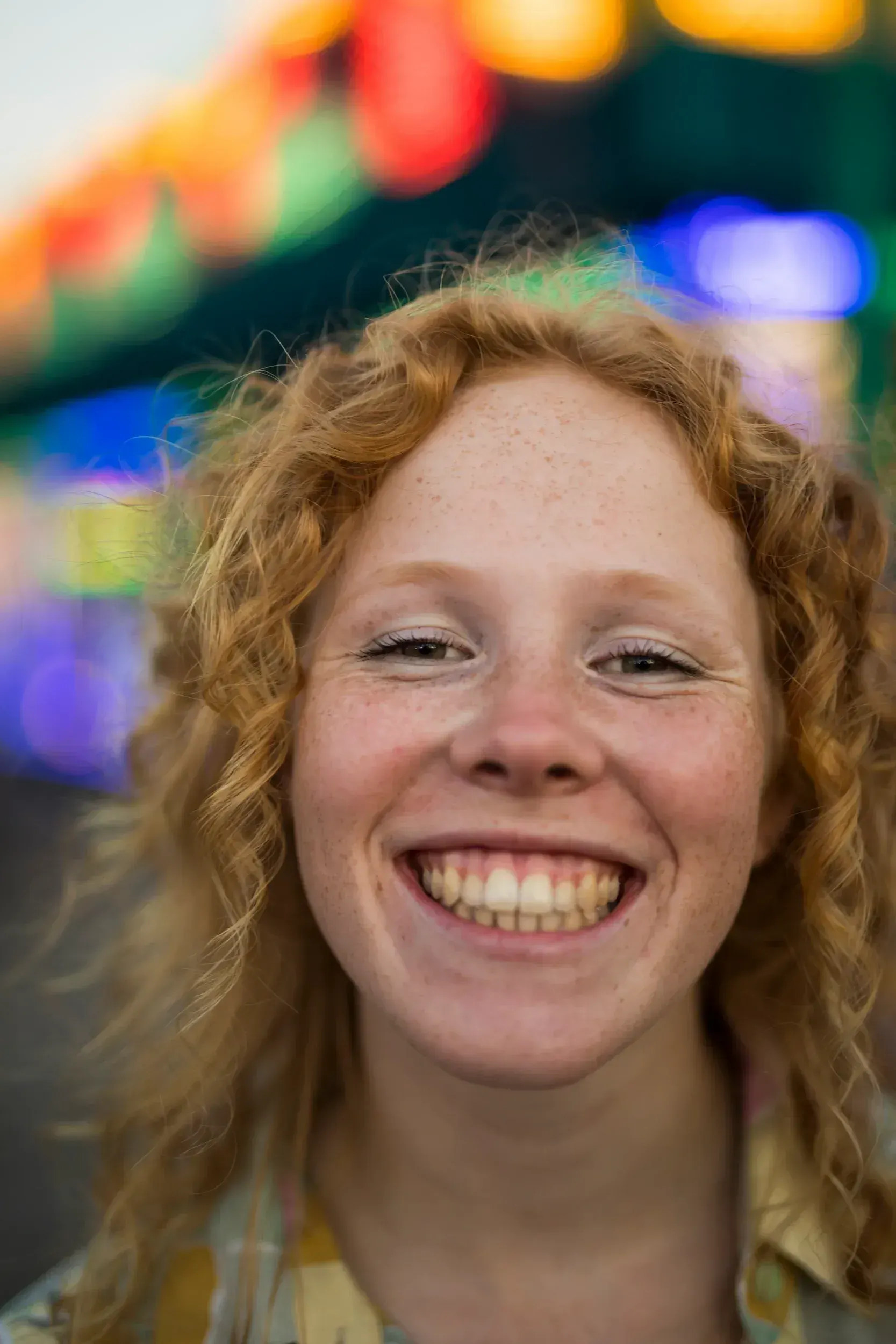Patient looking in mirror at yellowed front teeth before whitening